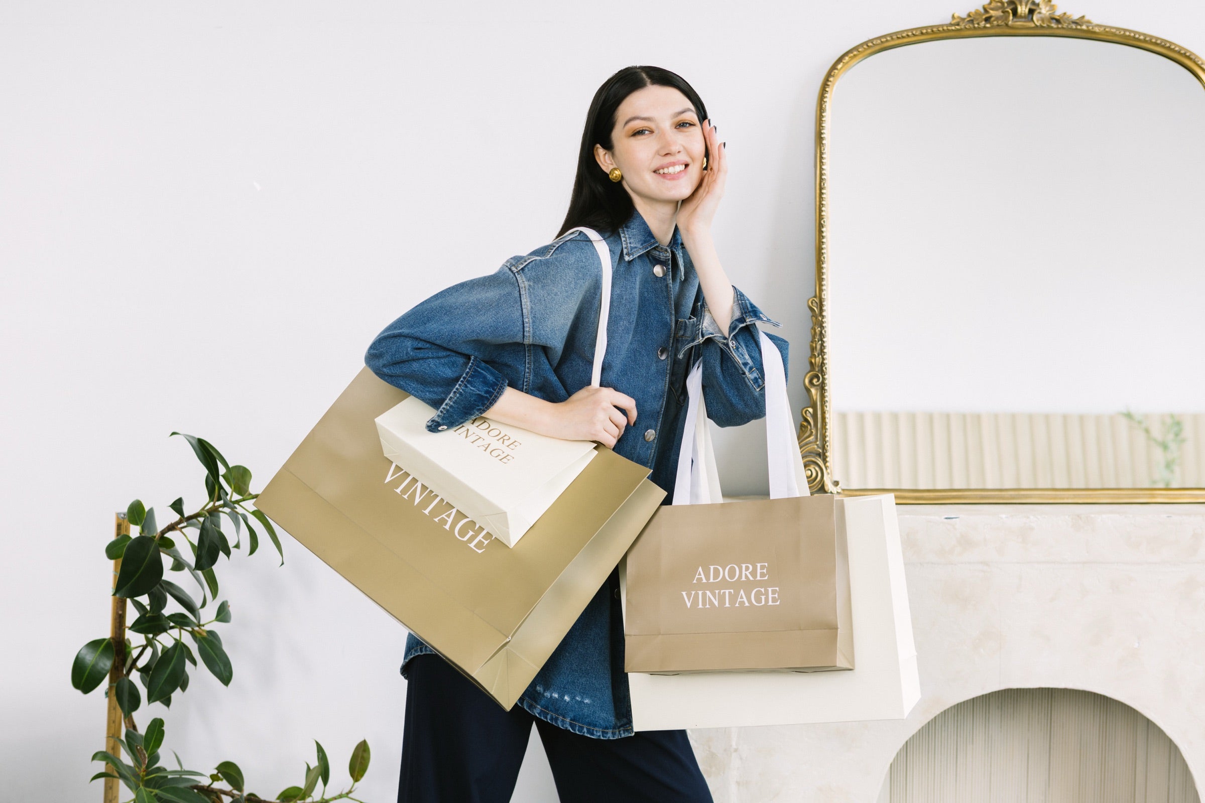 Adore Vintage studio portrait with branded shopping bags